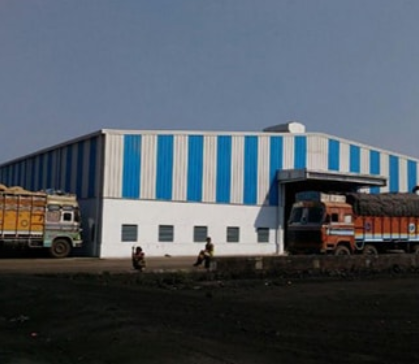Completed warehouse building with loading trucks